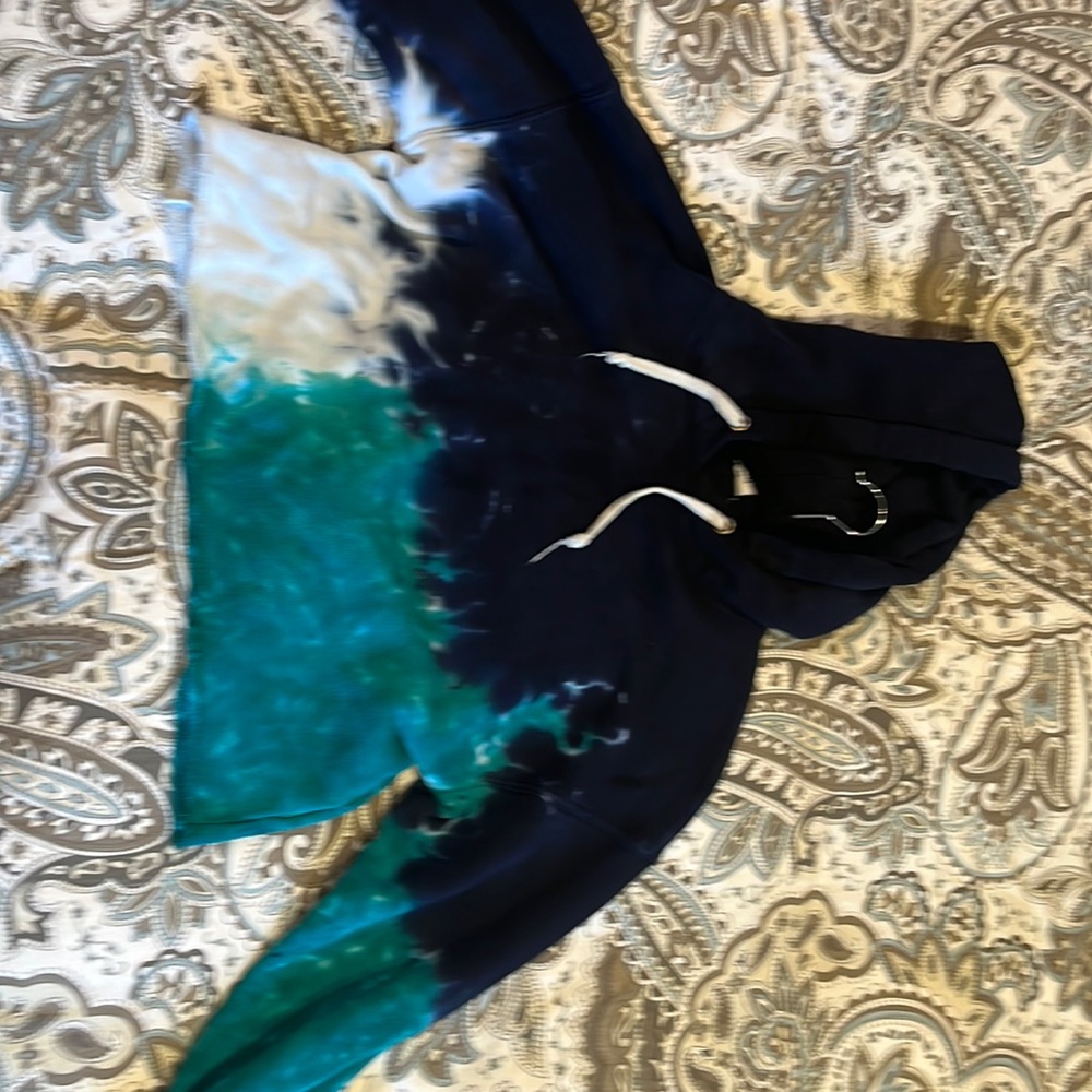 It’s a tie-dye, Hoodie, turquoise, blue, and white, barely worn